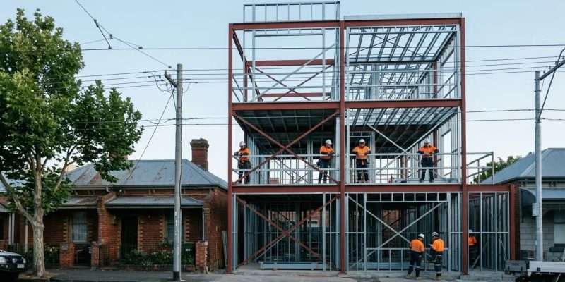 Melbourne medium-density townhouse construction site with structural steel frame, AS/NZS 5131 compliance